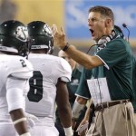 Sacramento State head coach Marshall Sperbeck, right, shouts after calling a timeout with players DeAndre Carter (2) and Ezekiel Graham (8) during the first half in an NCAA college football game against Arizona State on Thursday, Sept. 5, 2013, in Tempe, Ariz. (AP Photo/Ross D. Franklin)