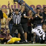 Arizona State's Taylor Kelly, bottom left, hangs on to the football as he beats Colorado's Kenneth Crawley (2) to the end zone as field judge Steven Strimling signals for the touchdown during the first half of an NCAA college football game on Saturday Oct. 12, 2013, in Tempe, Ariz. (AP Photo/Ross D. Franklin)