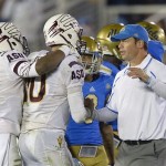 
UCLA head coach Jim Mora, right, congratulates Arizona State quarterback Taylor Kelly, center, and running back Deantre Lewis after Arizona State defeated UCLA in an NCAA college football game, Saturday, Nov. 23, 2013, in Pasadena, Calif. (AP Photo/Mark J. Terrill)
