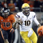 Arizona State quarterback Taylor Kelly, right, is pursued out of the pocket by Oregon State defender Rudolf Fifita during the first half of their NCAA college football game in Corvallis, Ore., Saturday, Nov. 3, 2012. (AP Photo/Don Ryan)