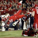 Arizona's Ka'Deem Carey (25) jumps over the end zone for a touchdown as teammate Drew Robinson (87) watches during the first half of an NCAA college football game against Arizona State at Arizona Stadium in Tucson, Ariz., Friday, Nov. 23, 2012. (AP Photo/Wily Low)
