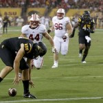 Arizona State punter Dom Vizzare, front left, loses the ball as Wisconsin's Chris Borland (44), Beau Allen (96) and Brendan Kelly (97) give chase and Arizona State's Carl Bradford (52) and Davon Coleman (43) also move in during the first half of an NCAA college football game on Saturday, Sept. 14, 2013, in Phoenix. Wisconsin's Allen recovered the ball in the end zone for a touchdown. (AP Photo/Ross D. Franklin)
