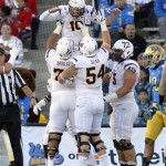 
Arizona State quarterback Taylor Kelly, top, celebrates his touchdown with offensive linesman Jamil Douglas, left, offensive linesman Tyler Sulka and offensive linesman Vi Teofilo as UCLA cornerback Fabian Moreau looks on during the first half an NCAA college football game, Saturday, Nov. 23, 2013, in Pasadena, Calif. (AP Photo/Mark J. Terrill)