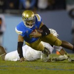 UCLA quarterback Brett Hundley, left, is tackled by Arizona State linebacker Chris Young during the second half an NCAA college football game, Saturday, Nov. 23, 2013, in Pasadena, Calif. (AP Photo/Mark J. Terrill)