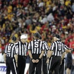 Game officials meet at midfield before an NCAA college football game between Arizona State and Arizona at Arizona Stadium in Tucson, Ariz., Friday, Nov. 23, 2012. (AP Photo/John Miller)
