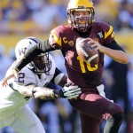 Arizona State quarterback Taylor Kelly (10) is chased down by Washington linebacker Cory Littleton, left, during the first half of an NCAA college football game, Saturday, Oct. 19, 2013, in Tempe, Ariz. (AP Photo/Matt York)