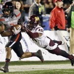Texas Tech wide receiver Reginald Davis, left, beats Arizona State cornerback Osahon Irabor for a 38-yard pass completion during the first half of the Holiday Bowl NCAA college football game, Monday, Dec. 30, 2013, in San Diego. (AP Photo/Gregory Bull)