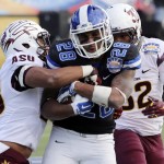 Duke's Shaquille Powell, center, clings to the ball as he is hit by Arizona State defenders during the third quarter of the Sun Bowl NCAA college football game, Saturday, Dec. 27, 2014, in El Paso, Texas. (AP Photo/Victor Calzada)