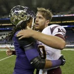 Arizona State quarterback Taylor Kelly, right, embraces Washington's Shaq Thompson after an NCAA college football game Saturday, Oct. 25, 2014, in Seattle. Arizona State won 24-10. (AP Photo/Elaine Thompson)