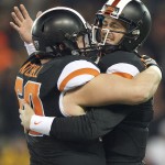 Oregon State quarterback Sean Mannion (4), right, celebrates with center Josh Mitchell (60) as the clock runs down during an NCAA college football game against Arizona State in Corvallis, Or., Saturday, Nov. 15, 2014. The Beavers beat the Sun Devils 35-27. (AP Photo/Troy Wayrynen)