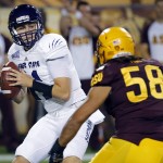 Weber State quarterback Billy Green, left, tries to avoid a sack by Arizona State linebacker Salamo Fiso during the first half of an NCAA college football game, Thursday, Aug. 28, 2014, in Tempe, Ariz. (AP Photo/Matt York)