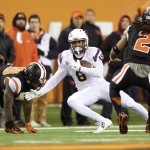 Arizona State tailback D.J. Foster (8) breaks away from an Oregon State defender during the first quarter of an NCAA college football game in Corvallis, Ore., Saturday, Nov. 15, 2014. (AP Photo/Troy Wayrynen)