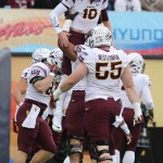 Arizona State quarterback Taylor Kelly was hoisted by teammates after scoring during the first quarter of the Sun Bowl NCAA college football game against Duke, Saturday, Dec. 27, 2014, in El Paso, Texas. (AP Photo/Victor Calzada)