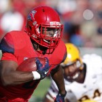 Arizona running back Nick Wilson (28) scores a touchdown during the first half of an NCAA college football game against Arizona State, Friday, Nov. 28, 2014, in Tucson, Ariz. (AP Photo/Rick Scuteri)