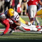 New Mexico's Clayton Mitchem, left, fumbles the ball as he is tackled by Arizona State's Viliami Moeakiola during the first half of an NCAA college football game Saturday, Sept. 6, 2014, in Albuquerque, N.M. (AP Photo/Ross D. Franklin)