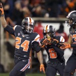 Oregon State tailback Storm Woods (24) celebrates with teammates Victor Bolden (6) and Jordan Villain (13), right, after scoring a touchdown against Arizona State during the first quarter of an NCAA college football game in Corvallis, Ore., Saturday, Nov. 15, 2014. (AP Photo/Troy Wayrynen)