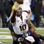 Arizona State quarterback Taylor Kelly tries to get off a pass while being brought down by Washington's Andrew Hudson during the first half of an NCAA college football game Saturday, Oct. 25, 2014, in Seattle. (AP Photo/Elaine Thompson)