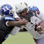 Arizona State's Demario Richard, right, tries to fend off a tackle by Duke's DeVon Edwards during the second quarter of the Sun Bowl NCAA college football game, Saturday, Dec. 27, 2014, in El Paso, Texas. (AP Photo/Victor Calzada)