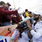 Arizona State players Manny Wilkins, right, and DJ Calhoun carry the trophy to fans after defeating Duke in the Sun Bowl NCAA college football game, Saturday, Dec. 27, 2014, in El Paso, Texas. Arizona State won 36-31. (AP Photo/Victor Calzada)