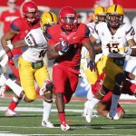 Arizona running back Nick Wilson (28) scores a touchdown during the second half of an NCAA college football game against Arizona State, Friday, Nov. 28, 2014, in Tucson, Ariz. (AP Photo/Rick Scuteri)