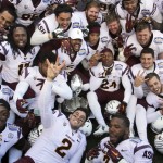 Arizona State players celebrate with the trophy following their 36-31 victory over Duke in the Sun Bowl NCAA college football game, Saturday, Dec. 27, 2014, in El Paso, Texas. (AP Photo/Victor Calzada)