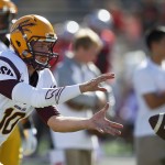 Arizona State quarterback Taylor Kelly catches the ball as his team warms up for an NCAA college football game against New Mexico on Saturday, Sept. 6, 2014, in Albuquerque, N.M. (AP Photo/Ross D. Franklin)