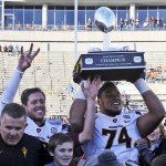 Arizona State's Jamil Douglas, right, hoists the trophy after their 36-31 win over Duke in the Sun Bowl NCAA college football game, Saturday, Dec. 27, 2014, in El Paso, Texas. Arizona State quarterback Taylor Kelly gestures, rear left. (AP Photo/Victor Calzada)