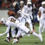 Oregon State receiver Jordan Villain (13) is tackled by Arizona State defenders James Johnson (18) and Lloyd Carrington during the second quarter of an NCAA college football game in Corvallis, Ore., Saturday, Nov. 15, 2014. (AP Photo/Troy Wayrynen)