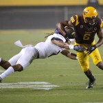 Arizona State wide receiver Cameron Smith (6) avoids the tackle of Weber State cornerback Cordero Dixon during the first half of an NCAA college football game, Thursday, Aug. 28, 2014, in Tempe, Ariz. (AP Photo/Matt York)