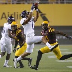Weber State wide receiver Shaydon Kehano makes a catch as Arizona State defensive back Damarious Randall (3) watches during the first half of an NCAA college football game, Thursday, Aug. 28, 2014, in Tempe, Ariz. (AP Photo/Matt York)