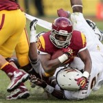 Southern California running back D.J. Morgan (30) is tackled by Arizona State linebacker Steffon Martin, bottom, during the second half of an NCAA college football game, Saturday, Nov. 10, 2012, in Los Angeles. Southern California won 38-17. (AP Photo/Bret Hartman)