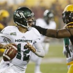 Sacramento State's Garrett Safron (12) scrambles away from Arizona State's Will Sutton during the first half in an NCAA college football game on Thursday, Sept. 5, 2013, in Tempe, Ariz. (AP Photo/Ross D. Franklin)
