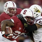 Stanford running back Remound Wright, front, is tackled by Arizona State cornerback Osahon Irabor during the second half of an NCAA college football game Saturday, Sept. 21, 2013, in Stanford, Calif. Stanford won 42-28. (AP Photo/Marcio Jose Sanchez)