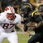 Arizona State's Marion Grice, right, carries the ball as he tries to get past Wisconsin's Ethan Hemer (87) in the first half of an NCAA college football game on Saturday, Sept. 14, 2013, in Phoenix. (AP Photo/Ross D. Franklin)
