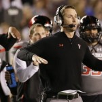 Texas Tech coach Kliff Kingsbury sends signals to his team during the first half of the Holiday Bowl NCAA college football game against Arizona State Monday, Dec. 30, 2013, in San Diego. (AP Photo/Gregory Bull)