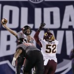 Texas Tech quarterback Davis Webb, left, throws a pass under pressure from Arizona State linebacker Carl Bradford, right, in the second half during the Holiday Bowl NCAA college football game Monday, Dec. 30, 2013, in San Diego. (AP Photo/Gregory Bull)