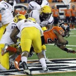 Oregon State running back Terron Ward, right, dives through the Arizona State offensive line during the first half of their NCAA college football game in Corvallis, Ore., Saturday, Nov. 3, 2012.(AP Photo/Don Ryan)