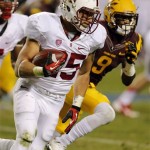 Stanford running back Tyler Gaffney (25) gains yards as Arizona State defensive back Robert Nelson (9) defends during the second half of the NCAA Pac-12 Championship football game, Saturday, Dec. 7, 2013, in Tempe, Ariz. (AP Photo/Matt York)