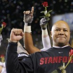 Stanford head coach David Shaw holds a rose after the NCAA Pac-12 Championship football game, Saturday, Dec. 7, 2013, in Tempe, Ariz. Stanford defeated Arizona State 38-14.(AP Photo/Matt York)
