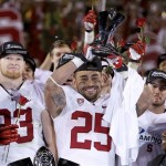 Stanford's Tyler Gaffney (25) holds up the most valuable player trophy as teammates, including Trent Murphy, second from left, enjoy the moment after the NCAA Pac-12 Championship football game win against Arizona State Saturday, Dec. 7, 2013, in Tempe, Ariz. Stanford defeated Arizona State 38-14. (AP Photo/Ross D. Franklin)