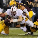 Stanford quarterback Kevin Hogan dives for a first down as he his pulled down by Arizona State defenders during the first half of the NCAA Pac-12 Championship football game, Saturday, Dec. 7, 2013, in Tempe, Ariz. (AP Photo/Matt York)
