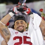 Stanford running back Tyler Gaffney (25) holds the most valuable player trophy after the NCAA Pac-12 Championship football game against Arizona State, Saturday, Dec. 7, 2013, in Tempe, Ariz. Stanford won 38-14.(AP Photo/Matt York)