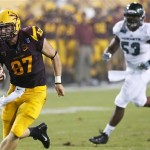 Arizona State's Chris Coyle (87) scores a touchdown ahead of Sacramento State's Todd Davis (53) during the first half in an NCAA college football game on Thursday, Sept. 5, 2013, in Tempe, Ariz. (AP Photo/Ross D. Franklin)