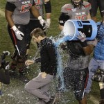 Texas Tech head coach Kliff Kingsbury, bottom left, is doused with an energy drink by Texas Tech defensive lineman Dennell Wesley, bottom right, after Texas Tech beat Arizona State in the Holiday Bowl NCAA college football game Monday, Dec. 30, 2013, in San Diego. (AP Photo/Gregory Bull)