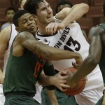 Miami guard Rion Brown (15) and Arizona State center Jordan Bachynski (13) battle in the second half of an NCAA men's college basketball game at the Wooden Legacy tournament in Anaheim, Calif., Sunday, Dec. 1, 2013. Miami won, 60-57. (AP Photo/Reed Saxon)