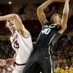 Colorado's Josh Scott (40) pulls down an offensive rebound in front of Arizona State's Jordan Bachynski (13) during the first half of an NCAA college basketball game Saturday, Jan. 25, 2014, in Tempe, Ariz. Arizona State defeated Colorado 72-51. (AP Photo/Ross D. Franklin)