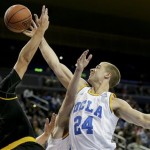 UCLA forward Travis Wear, right, blocks a shot by Arizona State guard Egor Koulechov during the first half of an NCAA college basketball game in Los Angeles, Sunday, Jan. 12, 2014. (AP Photo/Chris Carlson)