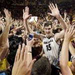 Arizona State's Jordan Bachynski (13) celebrates with fans after an NCAA college basketball game win against Arizona, Friday, Feb. 14, 2014, in Tempe, Ariz. Arizona State defeated Arizona 69-66 in double overtime. (AP Photo/Ross D. Franklin)