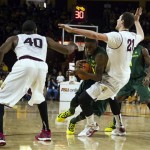 Oregon forward Elgin Cook, center, is fouled by Arizona State forward Eric Jacobsen (21) during an NCAA college basketball game on Saturday, Feb. 8, 2014, in Tempe, Ariz. (AP Photo/The Arizona Republic, Stacie Scott)