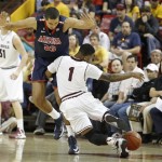 Arizona State's Jahii Carson (1) collides with Arizona's Grant Jerrett (33) as he tries to advance the ball up-court during the first half of an NCAA college basketball game, Saturday, Jan. 19, 2013, in Tempe, Ariz. Arizona won 71-54. (AP Photo/Ralph Freso)

